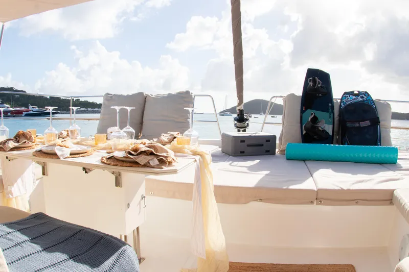  Yacht Photos Pics Luxurious Bali 4.8 yacht deck with dining setup and water sports gear, 2021 model.