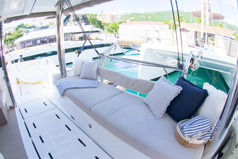  Yacht Photos Pics Luxurious Bali 4.8 yacht interior with comfortable seating and cushions, docked at a marina.