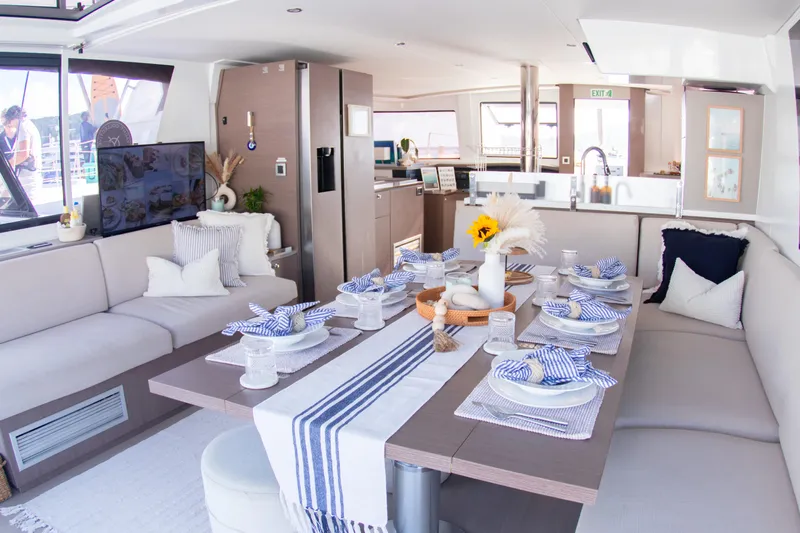  Yacht Photos Pics Luxurious interior of 2021 Bali 4.8 catamaran with elegant dining setup and modern decor.