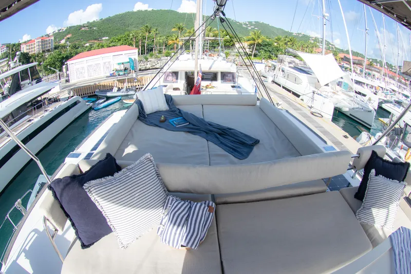  Yacht Photos Pics Luxurious Bali 4.8 catamaran deck with cozy seating, docked in a scenic marina.