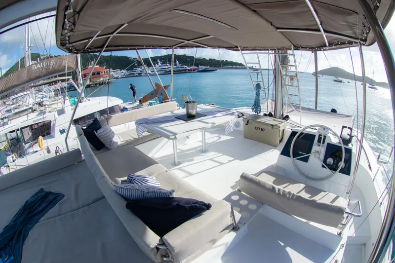 Yacht Photos Pics Luxurious 2021 Bali 4.8 catamaran with spacious deck and seating, docked in a scenic marina.