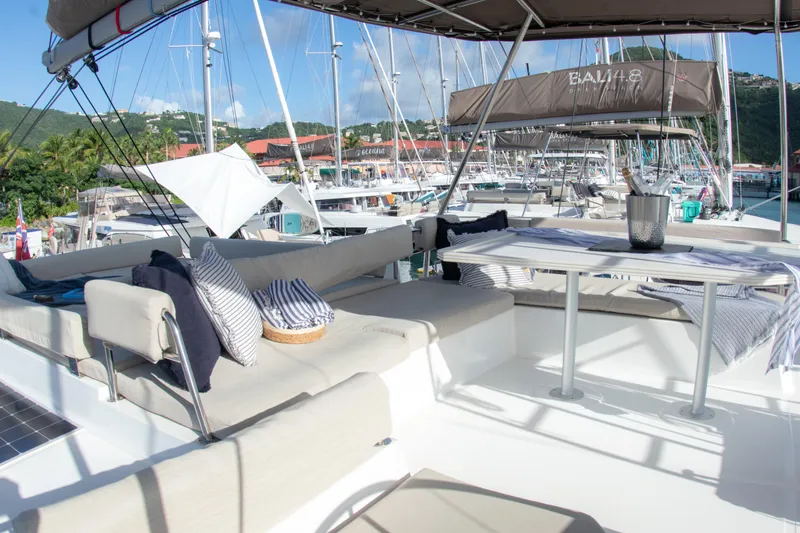  Yacht Photos Pics Luxurious 2021 Bali 4.8 yacht with spacious outdoor seating in a marina setting.