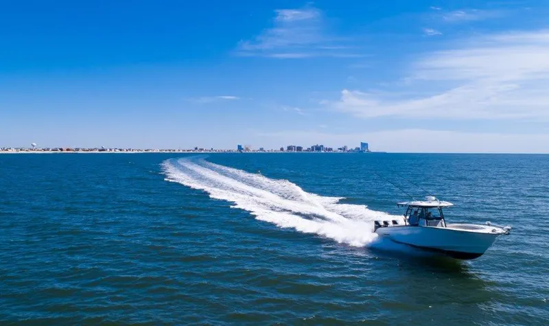  Yacht Photos Pics Cape Horn 36 XS 2022 boat cruising on open water with city skyline in background.