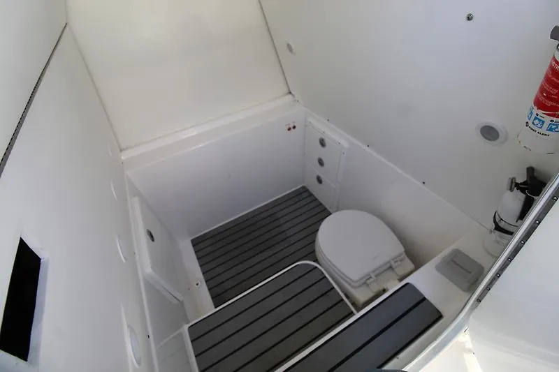  Yacht Photos Pics 2022 Cape Horn 36 XS boat interior bathroom with toilet and fire extinguisher.
