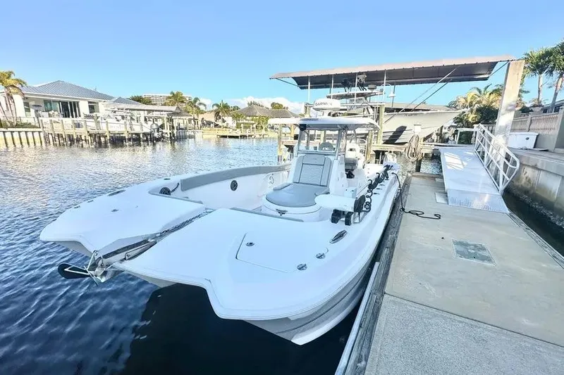  Yacht Photos Pics 2023 Twin Vee 340 GFX CC boat docked at a marina under clear skies.