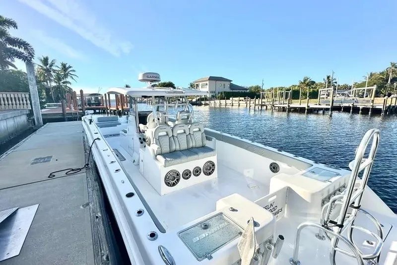  Yacht Photos Pics 2023 Twin Vee 340 GFX CC boat docked by a scenic waterfront.