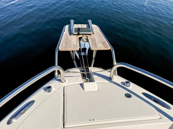  Yacht Photos Pics Bow view of 2025 Wellcraft 355 boat with stainless steel railings and wooden platform.
