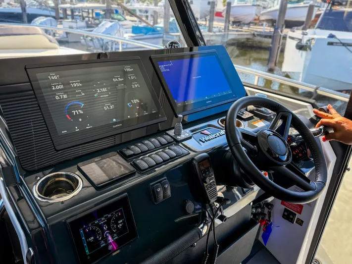  Yacht Photos Pics Cockpit of 2025 Wellcraft 355 boat with advanced navigation displays and controls.