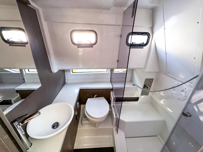  Yacht Photos Pics Modern bathroom interior of 2025 Wellcraft 355 boat, featuring sink, toilet, and shower.