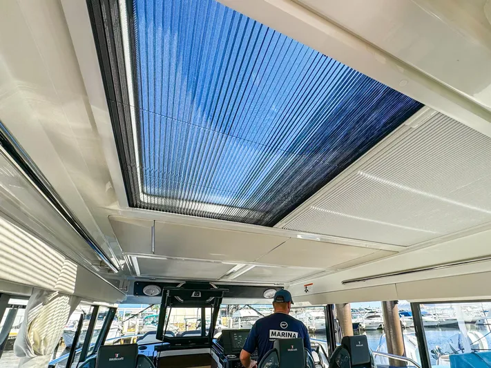  Yacht Photos Pics 2025 Wellcraft 355 boat interior with sunroof and marina view.