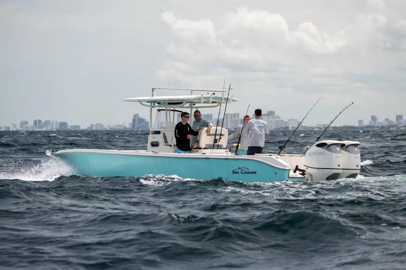  Yacht Photos Pics Manufacturer Provided Image: 2026 Sea Chaser 30 HFC CC boat on ocean with city skyline.