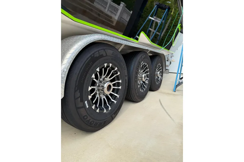  Yacht Photos Pics Triple-axle trailer with custom wheels for 2006 Fountain 38 CC Tournament Edition boat.