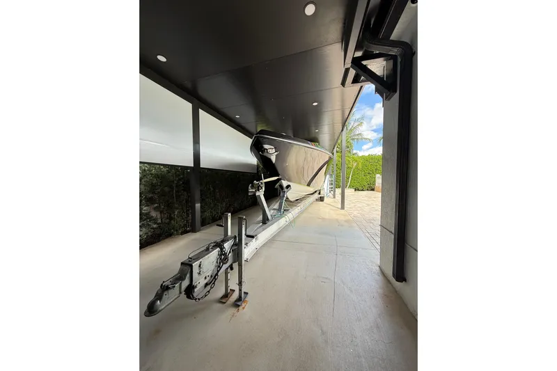  Yacht Photos Pics 2006 Fountain 38 CC Tournament Edition boat on trailer under a covered area.