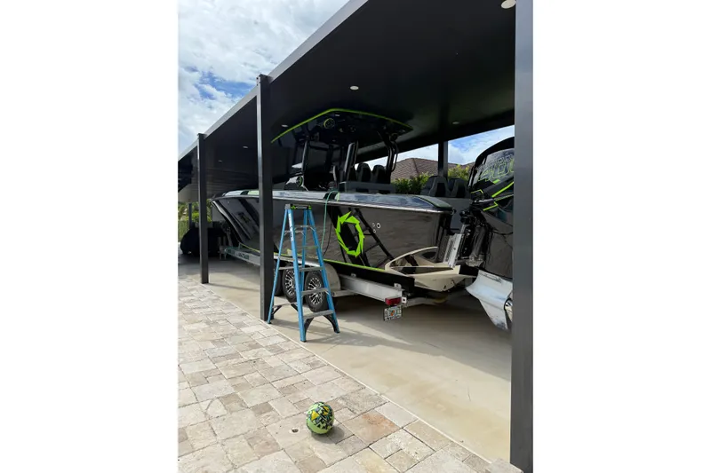  Yacht Photos Pics 2006 Fountain 38 CC Tournament Edition boat under a covered dock with a ladder nearby.