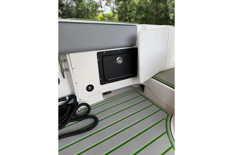  Yacht Photos Pics 2006 Fountain 38 CC Tournament Edition boat interior with storage compartment and green-accented flooring.