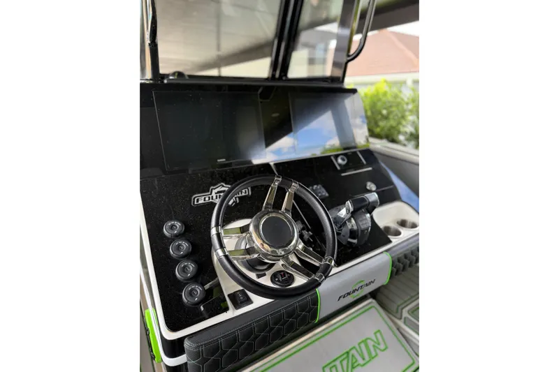  Yacht Photos Pics 2006 Fountain 38 CC Tournament Edition boat dashboard with steering wheel and controls.