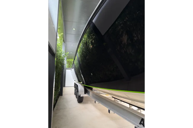  Yacht Photos Pics 2006 Fountain 38 CC Tournament Edition boat on trailer, sleek black hull.