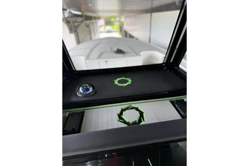  Yacht Photos Pics 2006 Fountain 38 CC Tournament Edition boat dashboard with compass and green accents.