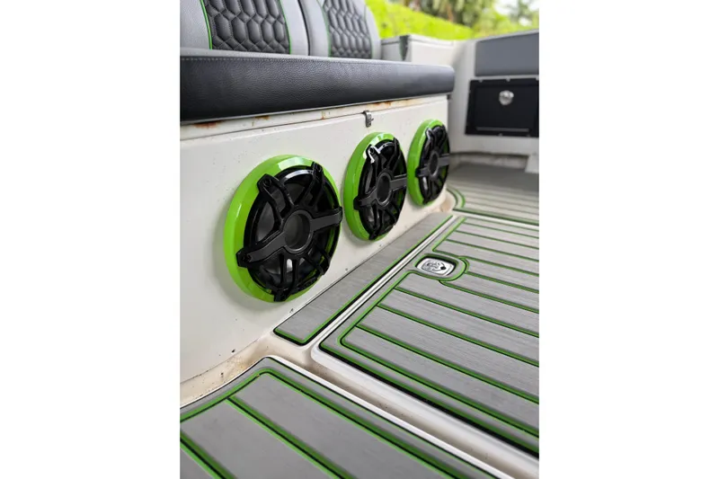  Yacht Photos Pics 2006 Fountain 38 CC Tournament Edition boat interior with green-accented speakers and flooring.