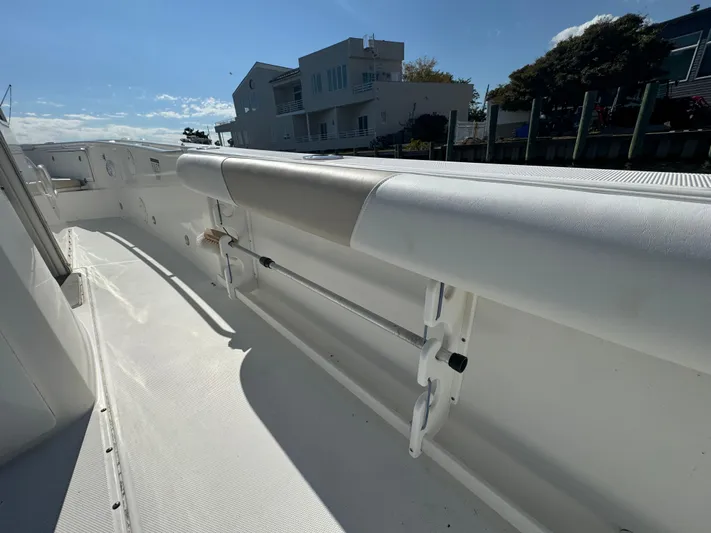  Yacht Photos Pics 2011 Everglades 325 Center Console boat deck with padded railing, docked near waterfront homes.