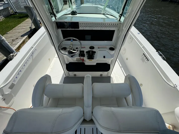  Yacht Photos Pics 2011 Everglades 325 Center Console boat interior with dual seats and steering console.