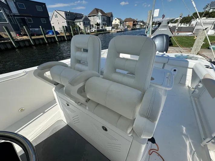  Yacht Photos Pics 2011 Everglades 325 Center Console boat with white seating, docked near waterfront homes.