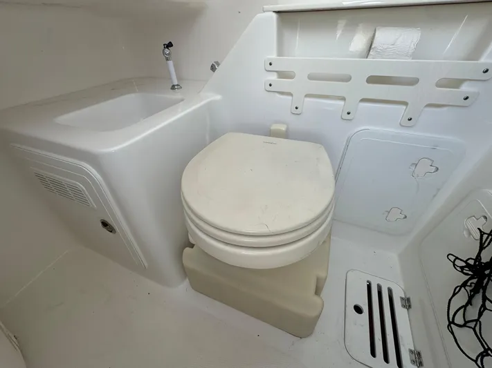  Yacht Photos Pics Interior of 2011 Everglades 325 Center Console boat with sink and toilet.