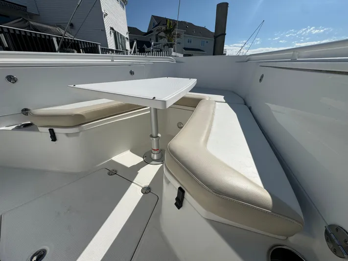  Yacht Photos Pics 2011 Everglades 325 Center Console boat interior with seating and table.