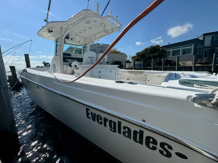  Yacht Photos Pics 2011 Everglades 325 Center Console boat docked, showcasing sleek design and spacious deck.