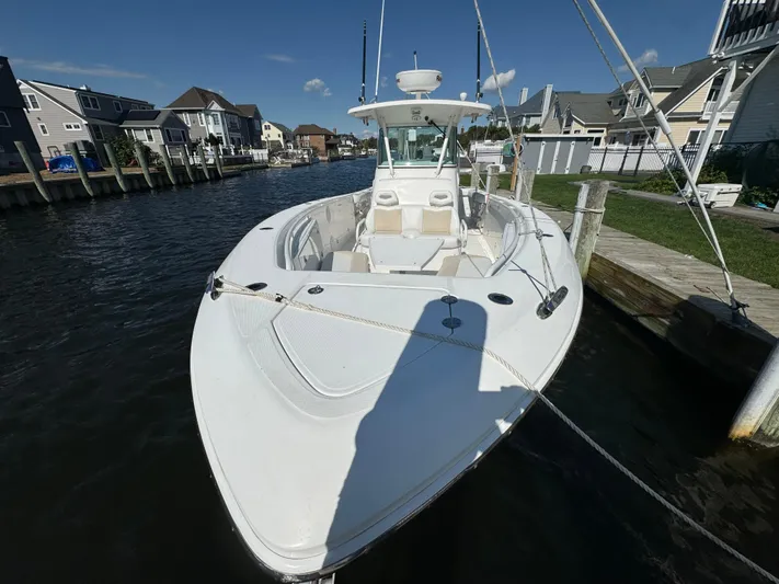  Yacht Photos Pics 2011 Everglades 325 Center Console boat docked in a residential canal.