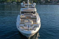 Luxurious 2018 Benetti 95 Delfino yacht on serene water, showcasing elegant design and spacious decks.