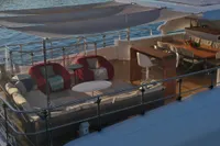 Luxurious 2018 Benetti 95 Delfino yacht deck with elegant seating and dining area.