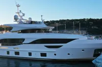 2018 Benetti 95 Delfino yacht on serene water, showcasing sleek design and luxury features.