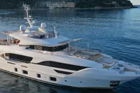 Luxurious 2018 Benetti 95 Delfino yacht cruising on serene blue waters.