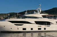 Luxurious 2018 Benetti 95 Delfino yacht cruising on serene waters.