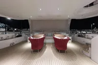 Luxurious 2018 Benetti 95 Delfino yacht deck with elegant seating at night.