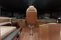 Interior of 2018 Benetti 95 Delfino yacht with luxurious wood and leather finishes.