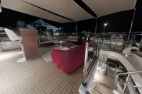 Luxurious 2018 Benetti 95 Delfino yacht deck at night, featuring elegant seating and modern design.