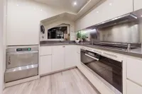Luxurious kitchen interior on 2018 Benetti 95 Delfino yacht, featuring modern appliances and sleek design.