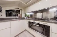 Modern kitchen interior on 2018 Benetti 95 Delfino yacht, featuring sleek cabinetry and appliances.