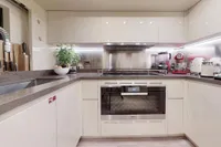 Modern kitchen in 2018 Benetti 95 Delfino yacht with sleek appliances and minimalist design.