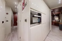 Luxurious interior of 2018 Benetti 95 Delfino yacht with modern kitchen and hallway.