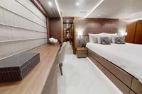 Luxurious bedroom interior of 2018 Benetti 95 Delfino yacht, featuring elegant furnishings and modern design.