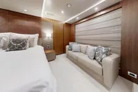 Luxurious bedroom interior on 2018 Benetti 95 Delfino yacht with elegant wood paneling.