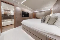 Luxurious bedroom interior of 2018 Benetti 95 Delfino yacht with modern design and elegant furnishings.