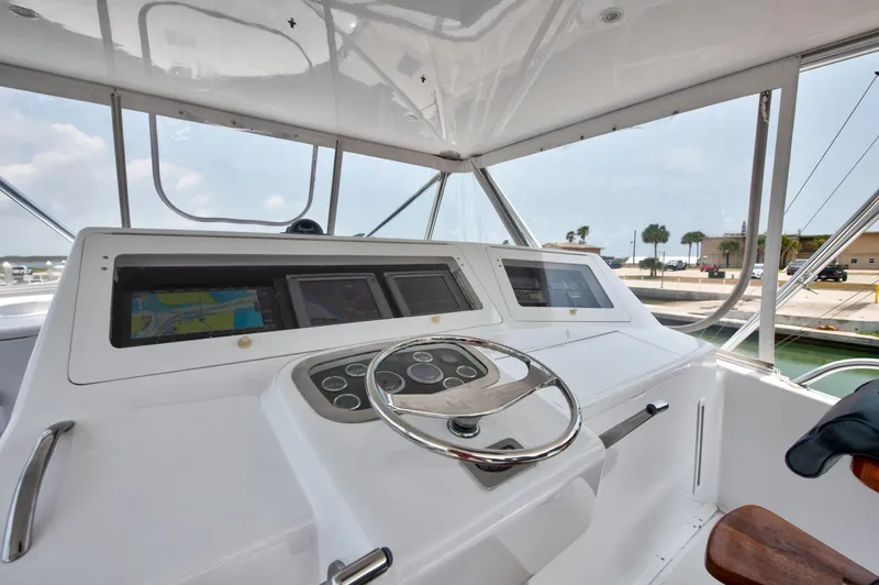  Yacht Photos Pics Helm station of 2001 Viking 55 Convertible yacht with modern navigation equipment.