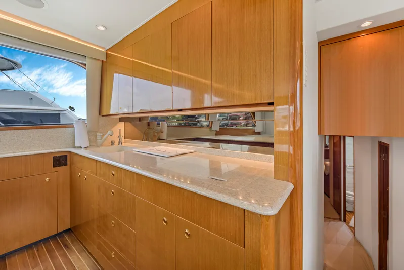  Yacht Photos Pics Luxurious kitchen interior of 2001 Viking 55 Convertible yacht with wooden cabinetry.