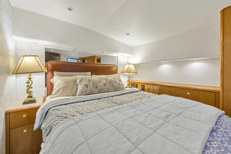  Yacht Photos Pics Luxurious bedroom interior of a 2001 Viking 55 Convertible yacht with elegant bedding and lamps.
