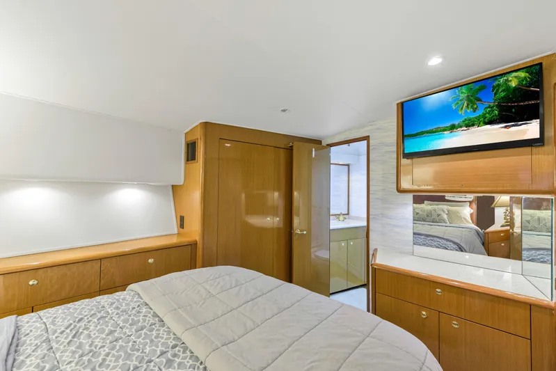  Yacht Photos Pics Luxurious bedroom in a 2001 Viking 55 Convertible yacht with TV and ensuite bathroom.