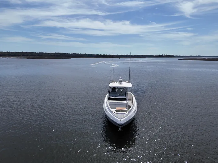  Yacht Photos Pics 2020 Regal 33 SAV boat on calm water under a clear blue sky.